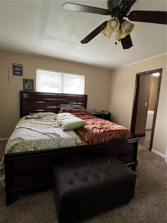 233 Main St, Osawatomie, KS 66064 - bedroom featuring carpet, a ceiling fan, and a textured ceiling