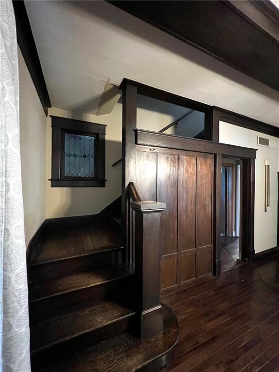 233 Main St, Osawatomie, KS 66064 - staircase featuring hardwood / wood-style flooring