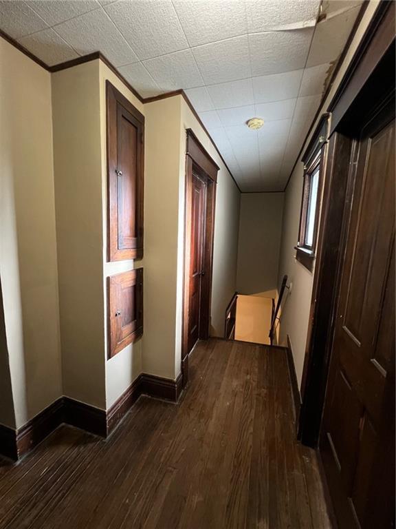 233 Main St, Osawatomie, KS 66064 - hall with dark wood-type flooring and crown molding