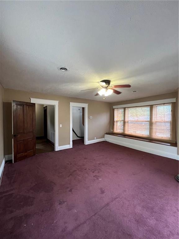 233 Main St, Osawatomie, KS 66064 - unfurnished bedroom featuring carpet floors and a ceiling fan