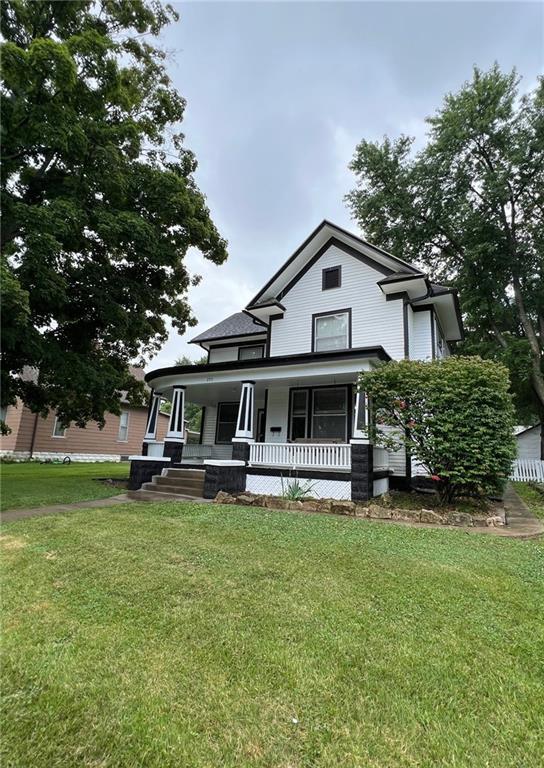 233 Main St, Osawatomie, KS 66064 - view of front of property featuring a porch and a front yard