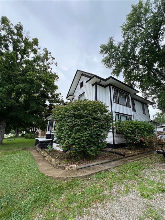 233 Main St, Osawatomie, KS 66064 - view of side of home with a lawn