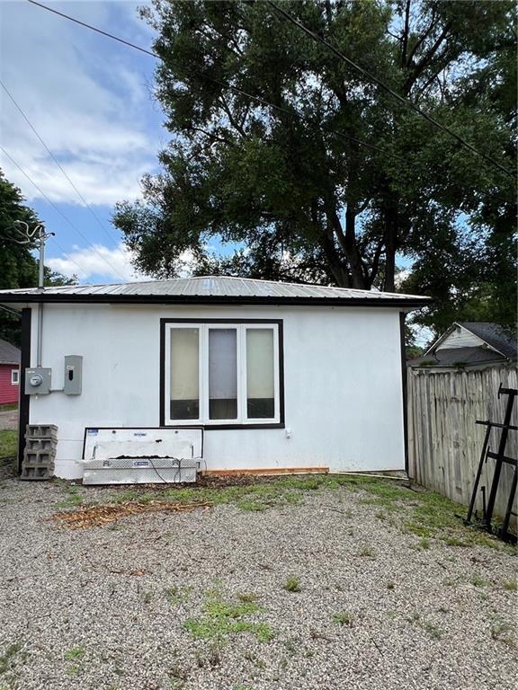233 Main St, Osawatomie, KS 66064 - view of home's exterior featuring stucco siding