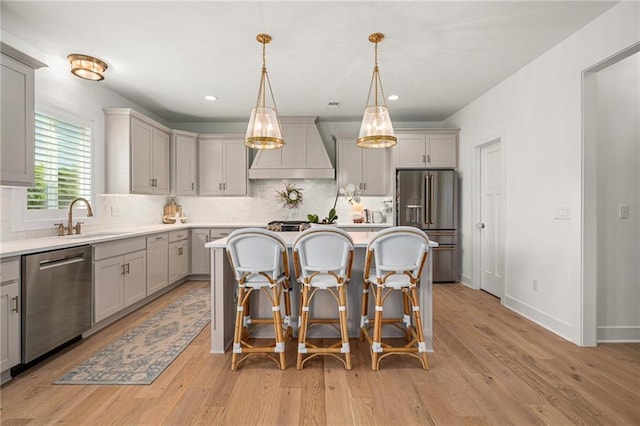 9010 N Denver Ave, Kansas City, MO 64156 - kitchen featuring appliances with stainless steel finishes, premium range hood, gray cabinetry, a center island, and recessed lighting