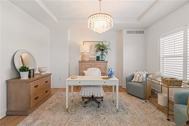 9010 N Denver Ave, Kansas City, MO 64156 - home office featuring a tray ceiling, wood finished floors, and a chandelier
