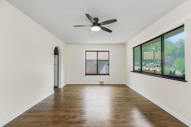 210 S 12th St, Leavenworth, KS 66048 - unfurnished room with a ceiling fan, arched walkways, and dark wood-style flooring