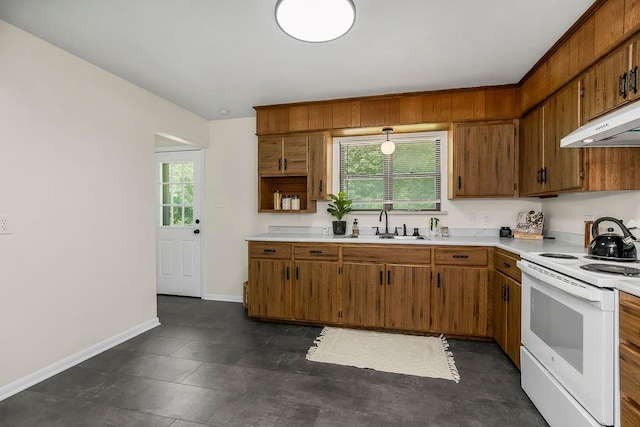 210 S 12th St, Leavenworth, KS 66048 - kitchen with white range with electric stovetop, brown cabinetry, light countertops, and under cabinet range hood