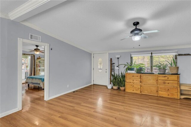 8036 Bellefontaine Ave, Kansas City, MO 64132 - unfurnished living room featuring a ceiling fan, light wood finished floors, a textured ceiling, and ornamental molding