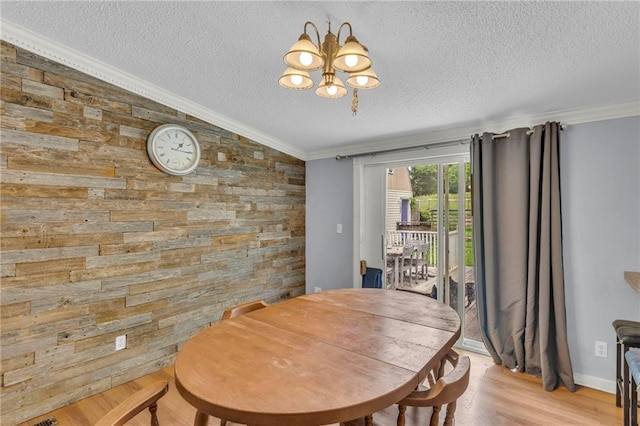 8036 Bellefontaine Ave, Kansas City, MO 64132 - dining room with a textured ceiling, lofted ceiling, a chandelier, wood finished floors, and ornamental molding