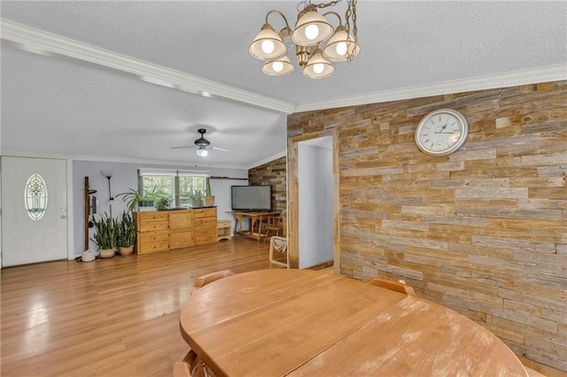 8036 Bellefontaine Ave, Kansas City, MO 64132 - dining room with a chandelier, wood finished floors, vaulted ceiling, crown molding, and a textured ceiling
