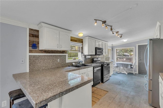 8036 Bellefontaine Ave, Kansas City, MO 64132 - kitchen with appliances with stainless steel finishes, a peninsula, white cabinets, decorative backsplash, and a textured ceiling