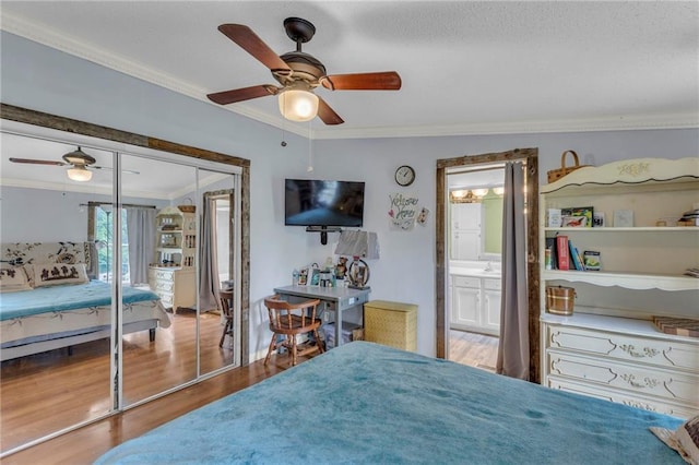 8036 Bellefontaine Ave, Kansas City, MO 64132 - bedroom featuring crown molding, wood finished floors, a ceiling fan, connected bathroom, and a closet