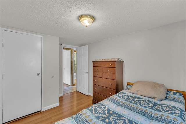 8036 Bellefontaine Ave, Kansas City, MO 64132 - bedroom with wood finished floors and a textured ceiling