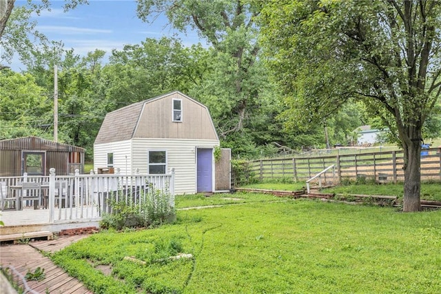 8036 Bellefontaine Ave, Kansas City, MO 64132 - fenced backyard featuring a wooden deck and an outdoor structure