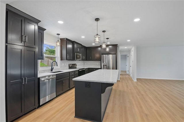 6600 W 93rd Ter, Overland Park, KS 66212 - kitchen featuring stainless steel appliances, a kitchen island, light wood finished floors, tasteful backsplash, and recessed lighting