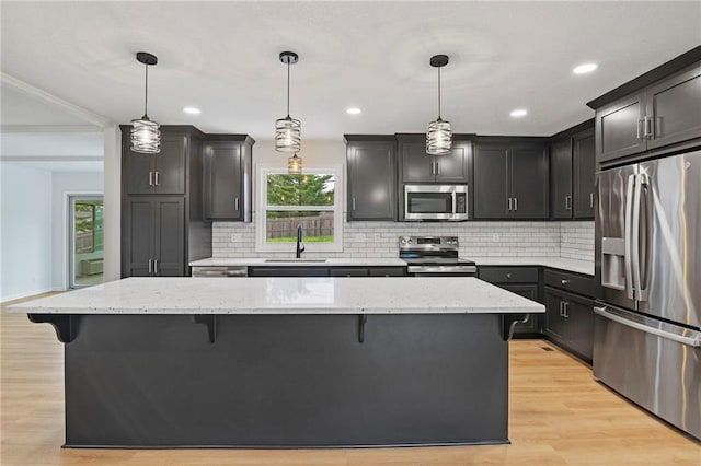 6600 W 93rd Ter, Overland Park, KS 66212 - kitchen with stainless steel appliances, a kitchen breakfast bar, plenty of natural light, decorative backsplash, and recessed lighting
