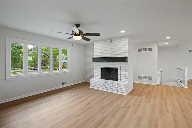 6600 W 93rd Ter, Overland Park, KS 66212 - unfurnished living room featuring a ceiling fan, light wood finished floors, recessed lighting, and a fireplace