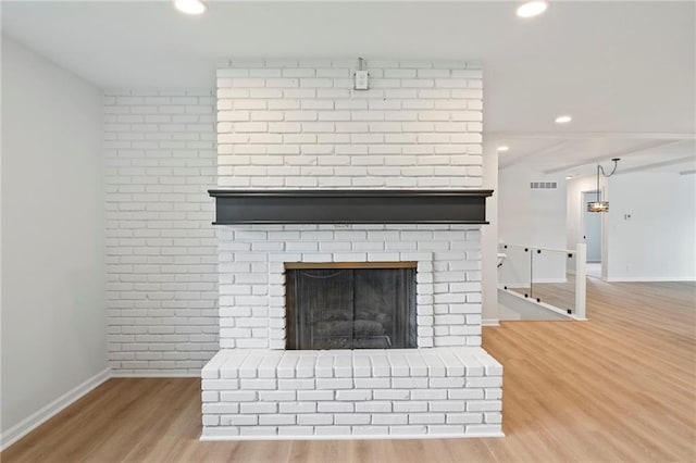 6600 W 93rd Ter, Overland Park, KS 66212 - detailed view of wood finished floors, recessed lighting, and a brick fireplace