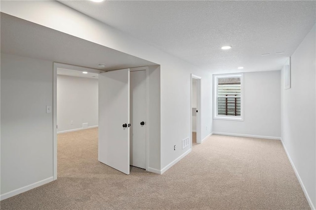 6600 W 93rd Ter, Overland Park, KS 66212 - below grade area with light carpet, recessed lighting, and a textured ceiling