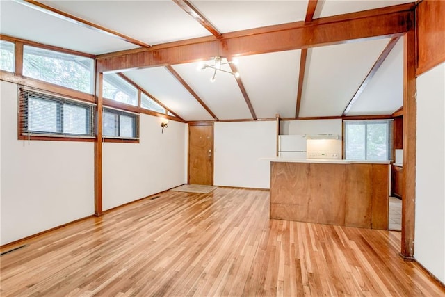 4400 N Brighton Ave, Kansas City, MO 64117 - unfurnished living room featuring light wood finished floors and healthy amount of natural light