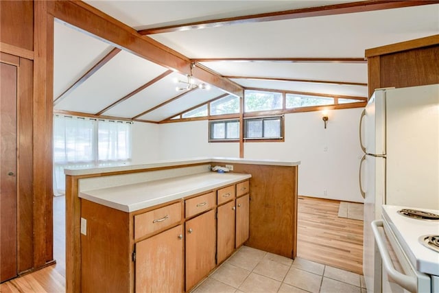 4400 N Brighton Ave, Kansas City, MO 64117 - kitchen with white electric range, light countertops, and light tile patterned flooring