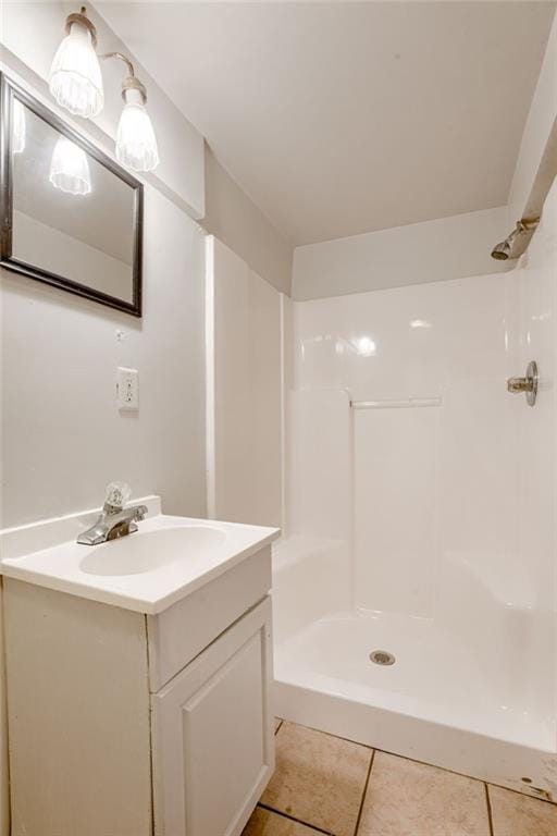 4400 N Brighton Ave, Kansas City, MO 64117 - bathroom with vanity, tile patterned flooring, and a shower