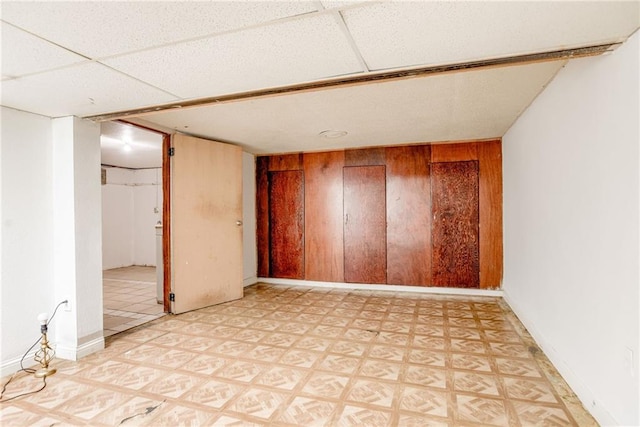 4400 N Brighton Ave, Kansas City, MO 64117 - spare room with light flooring and wood walls