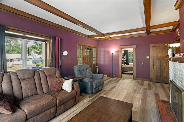 508 S Elm St, Ottawa, KS 66067 - living area featuring a brick fireplace, coffered ceiling, wood finished floors, beamed ceiling, and healthy amount of natural light