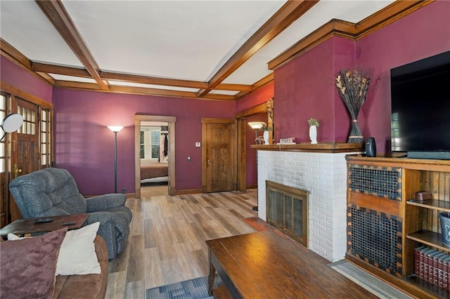 508 S Elm St, Ottawa, KS 66067 - living room featuring coffered ceiling, wood finished floors, a brick fireplace, and beam ceiling