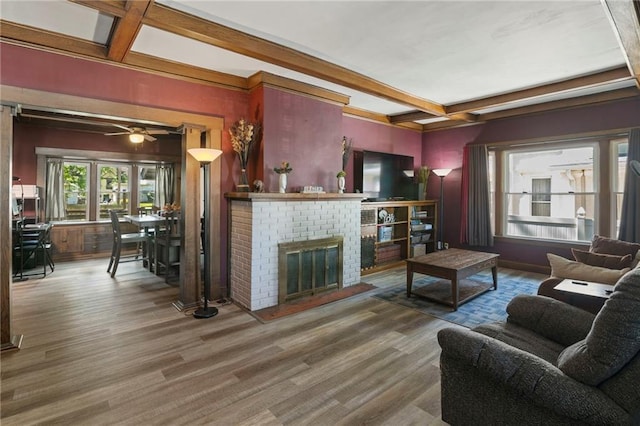 508 S Elm St, Ottawa, KS 66067 - living area featuring beamed ceiling, wood finished floors, a brick fireplace, ceiling fan, and coffered ceiling