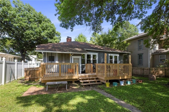 508 S Elm St, Ottawa, KS 66067 - rear view of property featuring a fenced backyard, a chimney, and a wooden deck