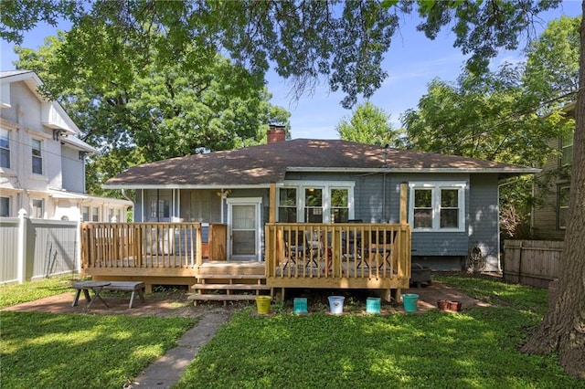 508 S Elm St, Ottawa, KS 66067 - back of property featuring a fenced backyard, a chimney, and a wooden deck