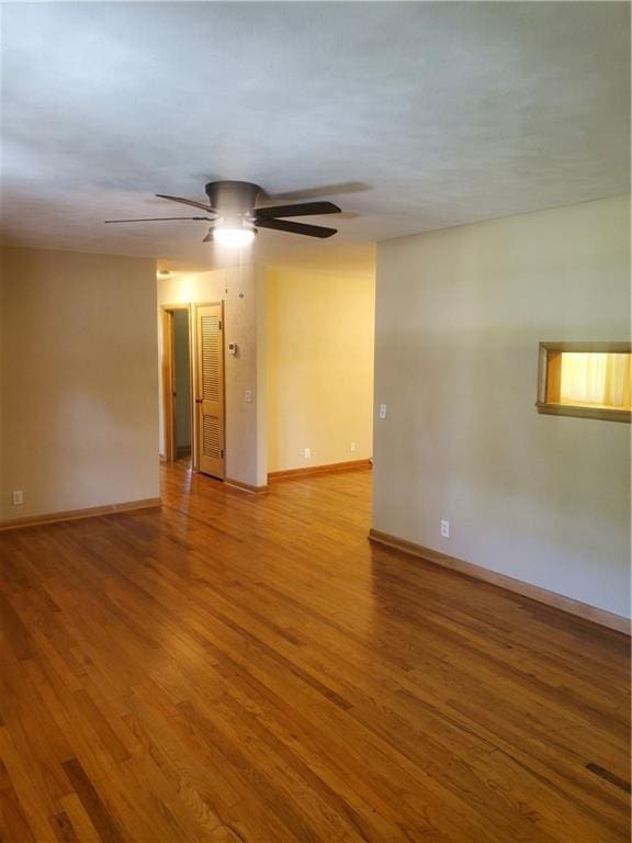 304 Swan St, Lacygne, KS 66040 - unfurnished room with wood finished floors and ceiling fan