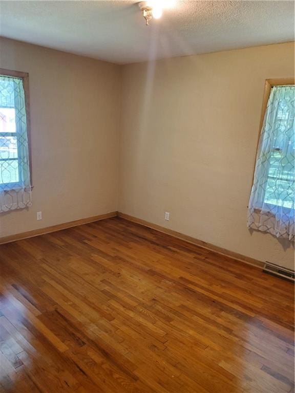 304 Swan St, Lacygne, KS 66040 - unfurnished room with wood finished floors and a textured ceiling