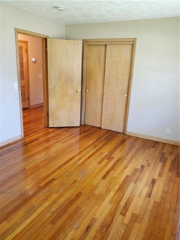 304 Swan St, Lacygne, KS 66040 - unfurnished bedroom featuring light wood-style floors and a closet