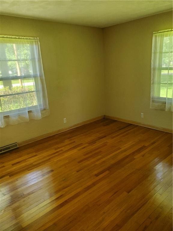 304 Swan St, Lacygne, KS 66040 - unfurnished room with hardwood / wood-style flooring and baseboards