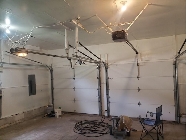304 Swan St, Lacygne, KS 66040 - garage featuring electric panel and a garage door opener