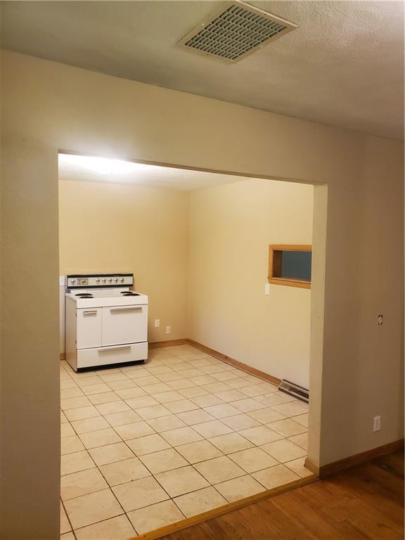 304 Swan St, Lacygne, KS 66040 - kitchen with electric range and light wood-style flooring