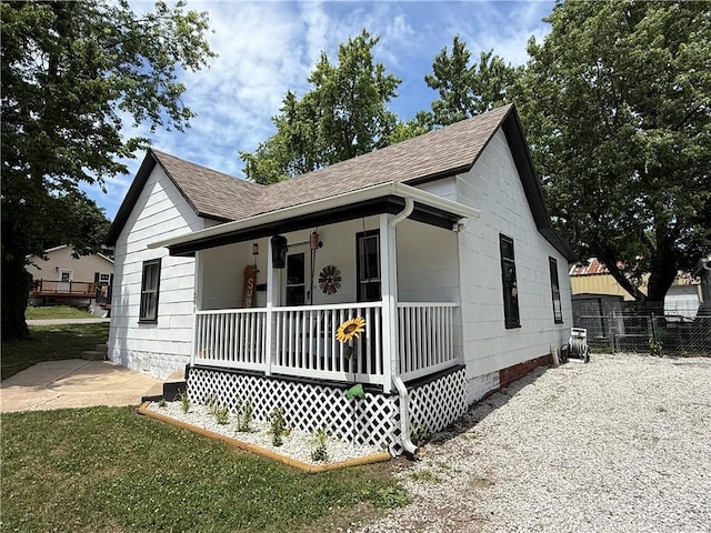 310 W 23rd St, Higginsville, MO 64037 - view of front facade with a porch, roof with shingles, and crawl space