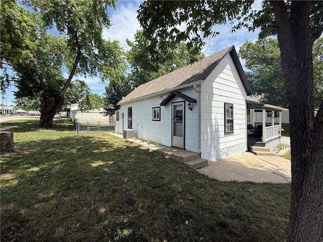 310 W 23rd St, Higginsville, MO 64037 - view of property exterior with a shingled roof and a porch