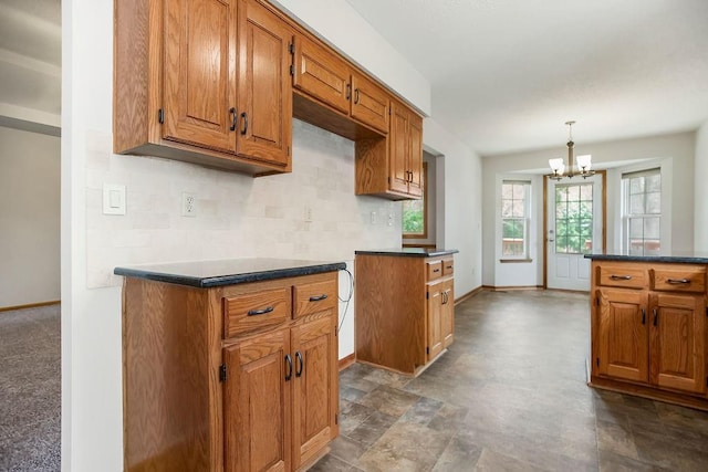 733 NE Colleen Dr, Lees Summit, MO 64086 - kitchen with a chandelier, brown cabinetry, backsplash, and dark countertops