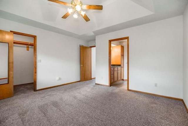 733 NE Colleen Dr, Lees Summit, MO 64086 - unfurnished bedroom with carpet flooring, a ceiling fan, connected bathroom, and a spacious closet