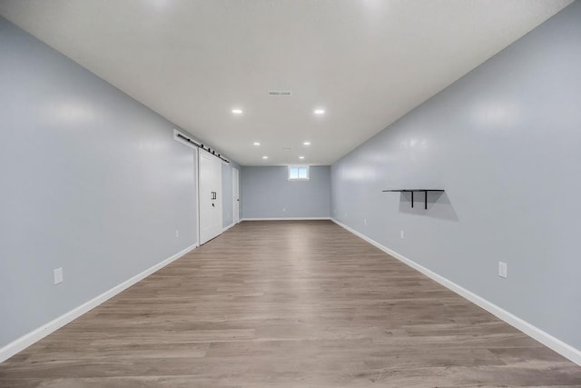 733 NE Colleen Dr, Lees Summit, MO 64086 - spare room featuring light wood-style flooring, recessed lighting, and a barn door