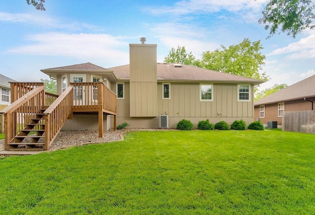 733 NE Colleen Dr, Lees Summit, MO 64086 - back of property with stairway, a wooden deck, a chimney, board and batten siding, and roof with shingles