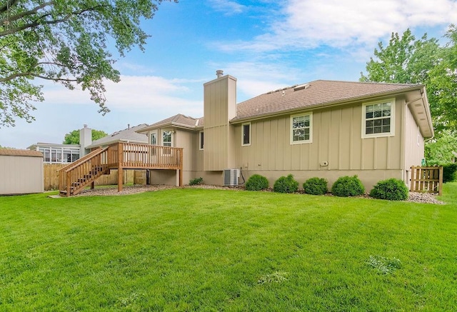 733 NE Colleen Dr, Lees Summit, MO 64086 - rear view of house with a deck, board and batten siding, stairway, and a chimney
