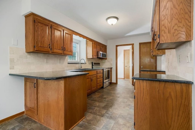 733 NE Colleen Dr, Lees Summit, MO 64086 - kitchen featuring appliances with stainless steel finishes, brown cabinets, a peninsula, decorative backsplash, and dark countertops