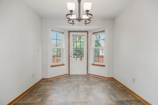 733 NE Colleen Dr, Lees Summit, MO 64086 - doorway featuring a chandelier and stone finish flooring