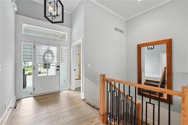 13300 W 174th Pl, Overland Park, KS 66221 - foyer with wood finished floors, crown molding, a chandelier, and a towering ceiling