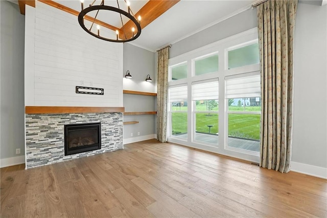 13300 W 174th Pl, Overland Park, KS 66221 - unfurnished living room with wood finished floors, a chandelier, ornamental molding, and a glass covered fireplace
