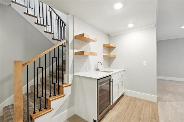 13300 W 174th Pl, Overland Park, KS 66221 - indoor wet bar with wine cooler, stairway, crown molding, light wood-style flooring, and decorative backsplash